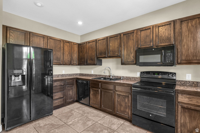 14108 Pepi Band Road Draper, UT 84020 - Photo 12 of 36 Kitchen featuring extensive wood cabinetry, coordinating countertops, and tile flooring