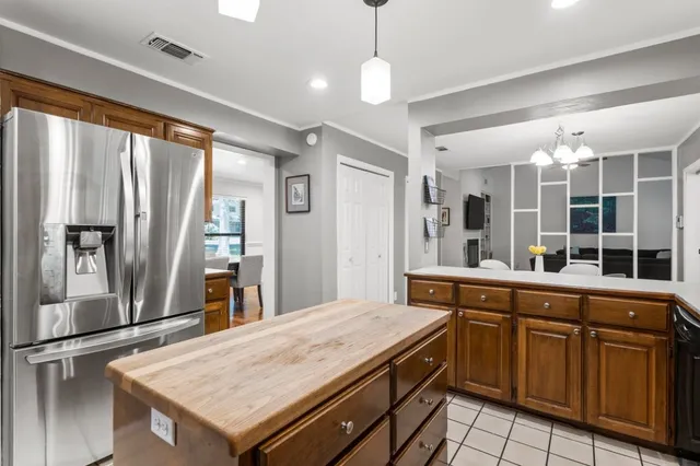 a large kitchen with kitchen island a large counter space appliances and cabinets