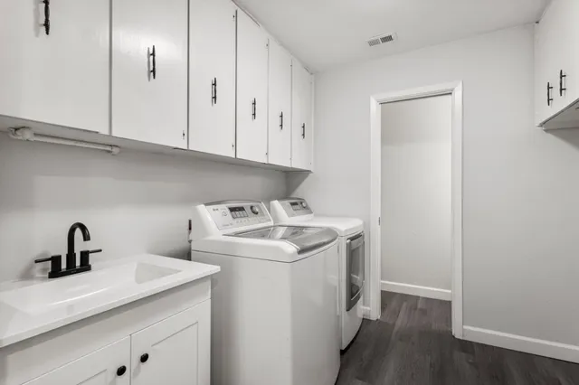 a utility room with sink dryer and washer