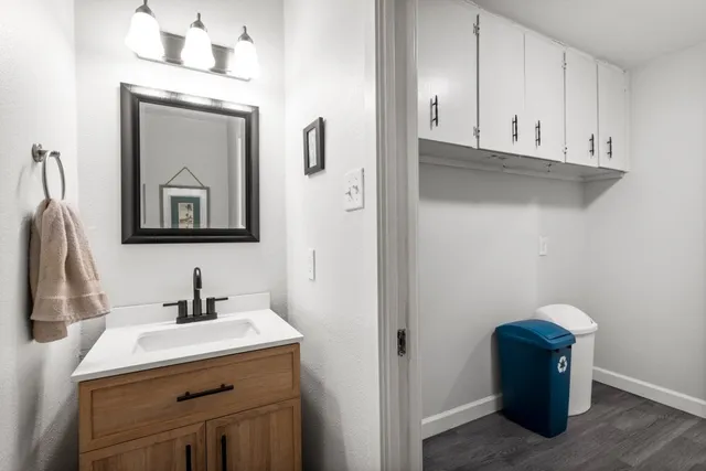 a bathroom with a sink vanity and mirror