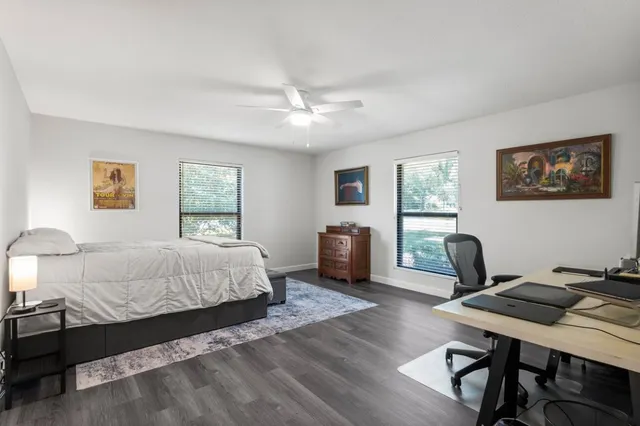 a bedroom with a bed window and a desk