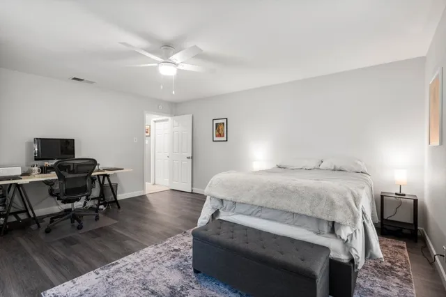 a bedroom with a bed and a desk