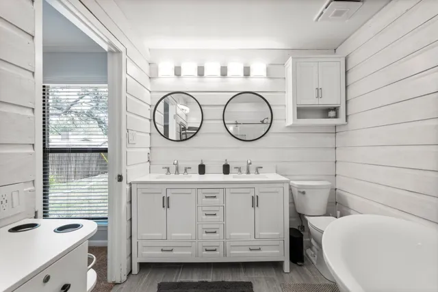 a kitchen with a cabinets and a clock on the wall