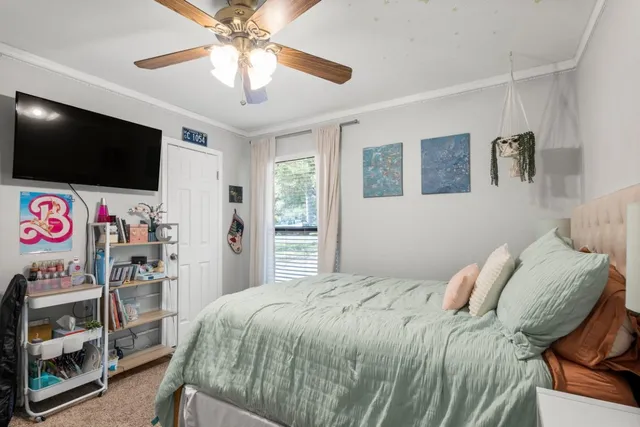 a bedroom with furniture and book shelf