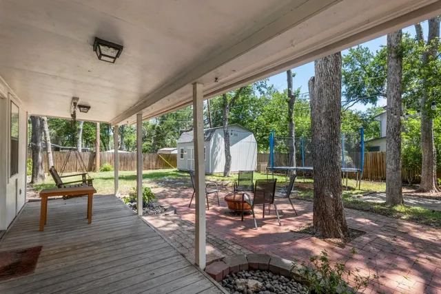 a view of a patio with table and chairs with wooden fence and plants