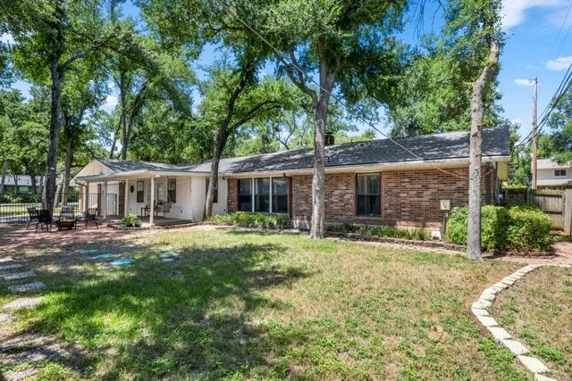 a front view of a house with a yard and porch