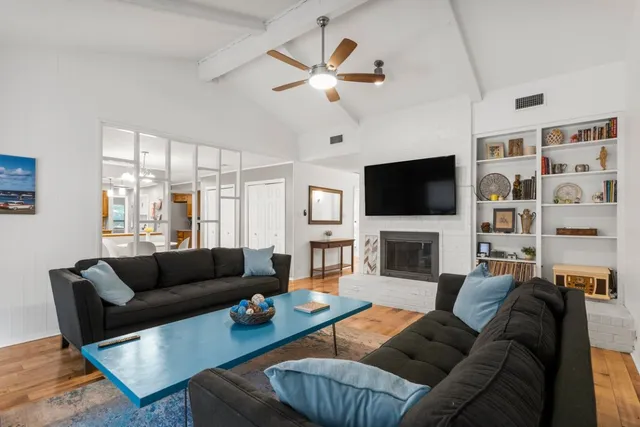 a living room with fireplace furniture and a flat screen tv