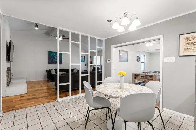 a view of a dining room with furniture and chandelier