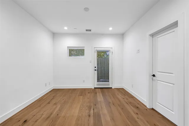 a kitchen with a refrigerator a sink and wooden floor