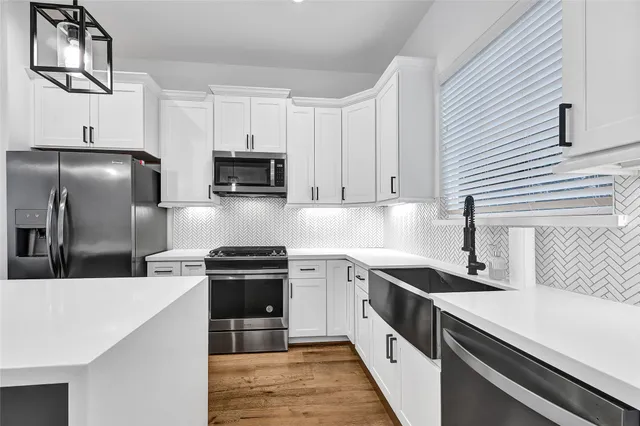a kitchen that has a kitchen island wooden floor and a window