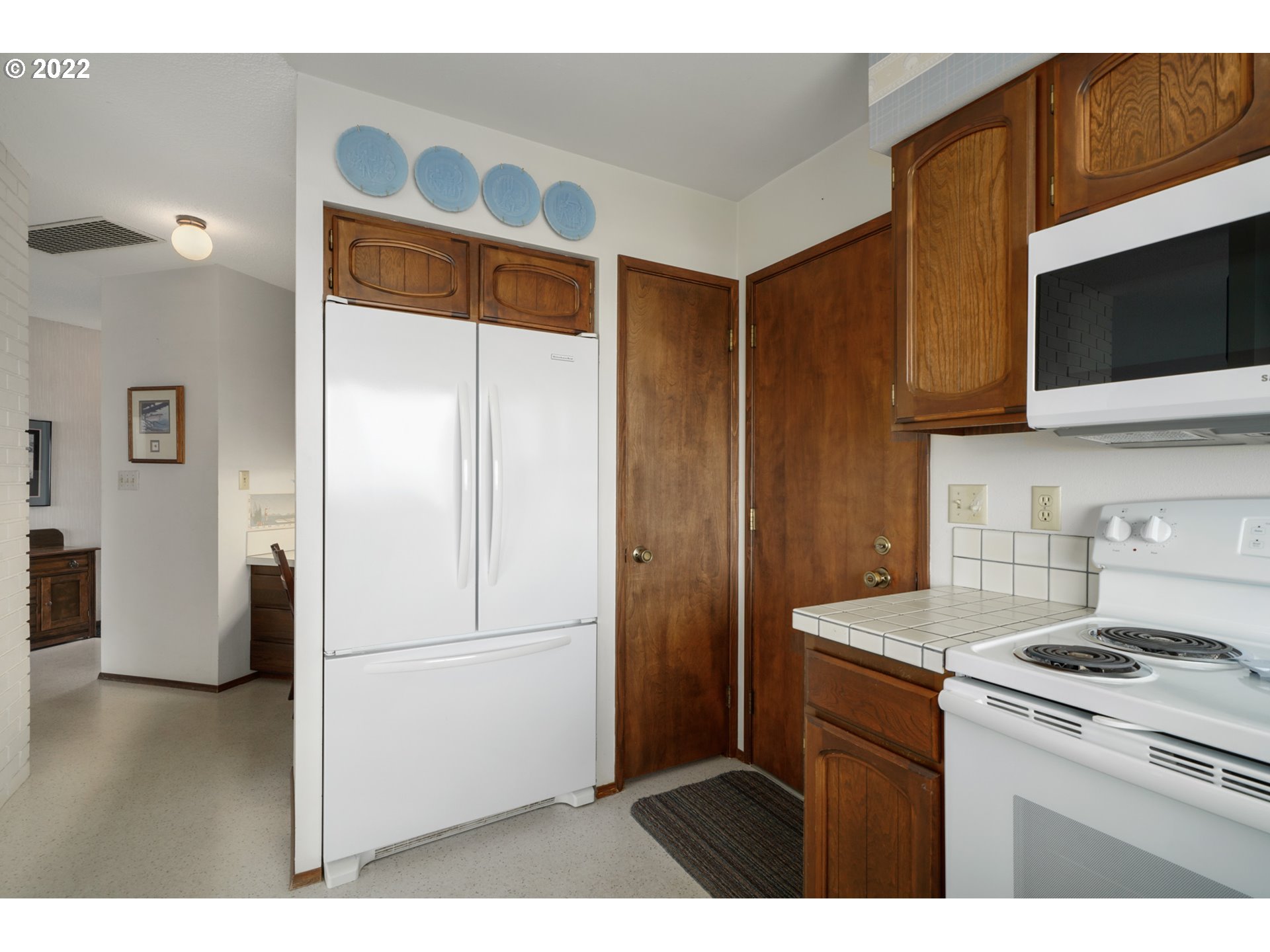 8125 Neahkahnie Road Nehalem, OR 97131 - Photo 11 of 32 a kitchen with stainless steel appliances a refrigerator and a stove top oven