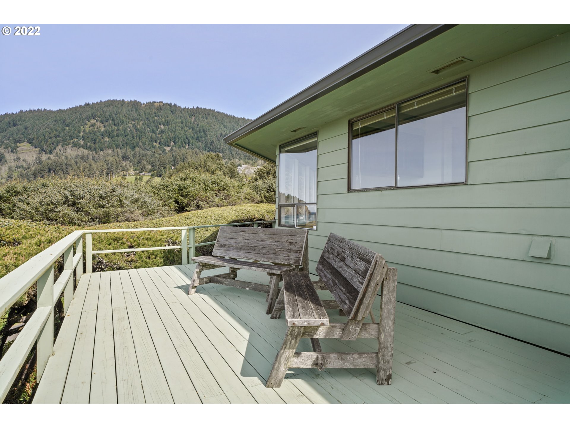8125 Neahkahnie Road Nehalem, OR 97131 - Photo 13 of 32 a balcony with wooden floor and furniture