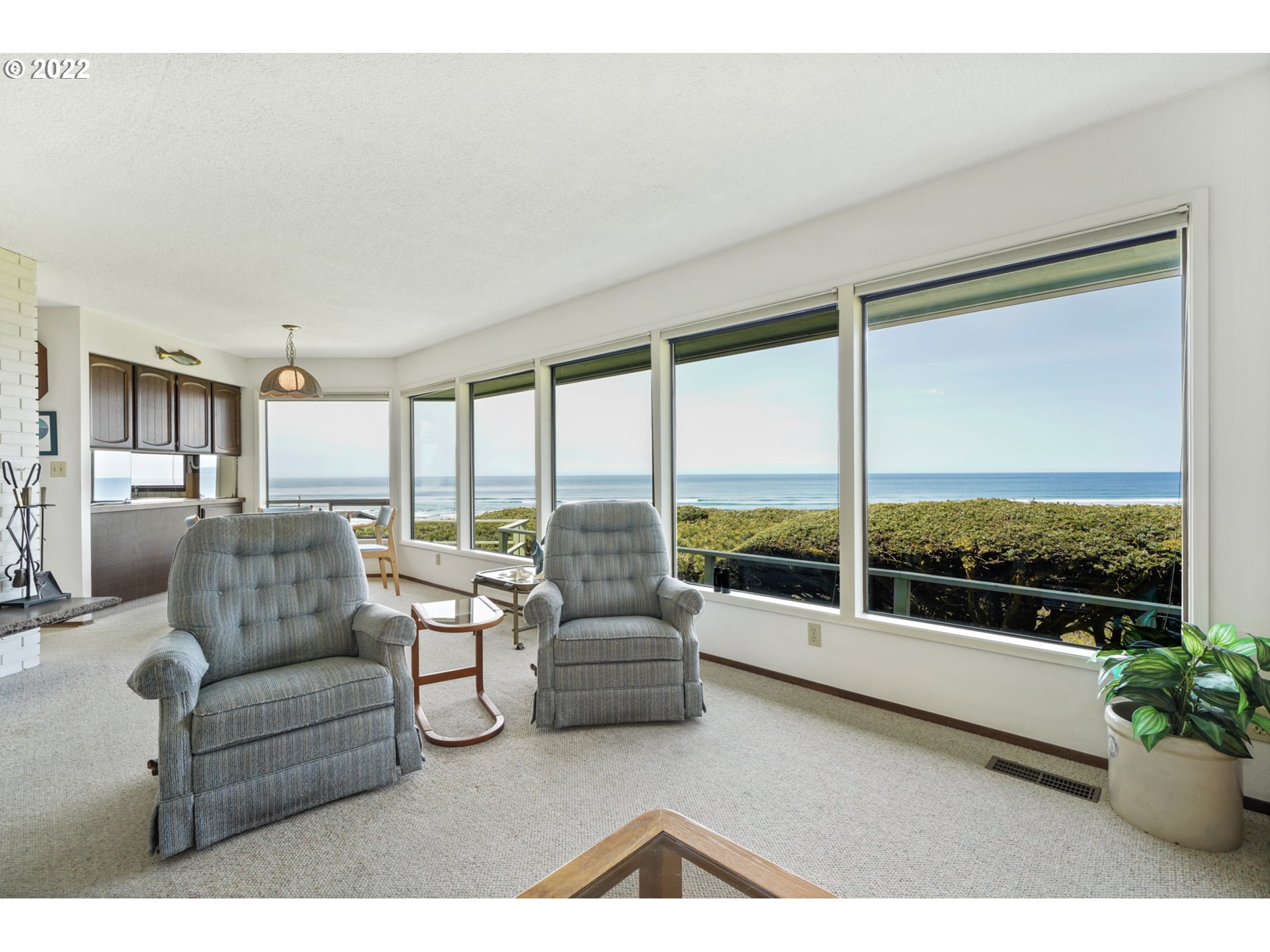 8125 Neahkahnie Road Nehalem, OR 97131 - Photo 17 of 32 a living room with furniture tv and large windows