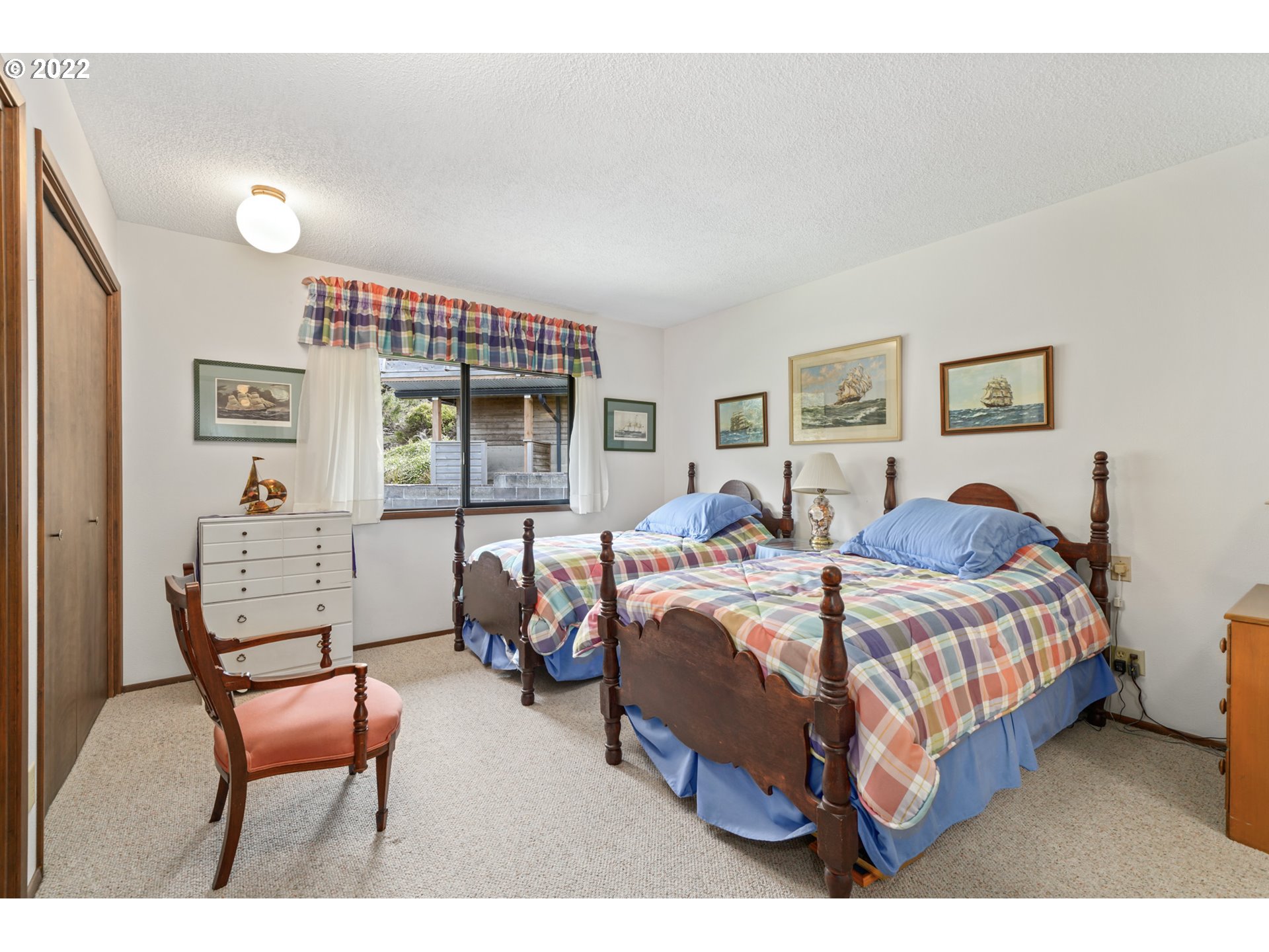 8125 Neahkahnie Road Nehalem, OR 97131 - Photo 19 of 32 a bedroom with a bed chair and window