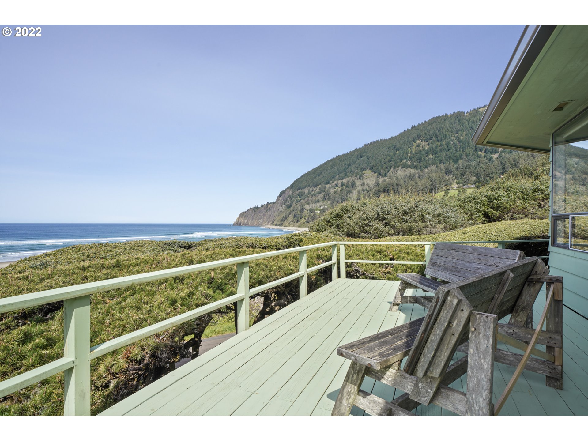 8125 Neahkahnie Road Nehalem, OR 97131 - Photo 2 of 32 a view of a balcony with chair and wooden floor