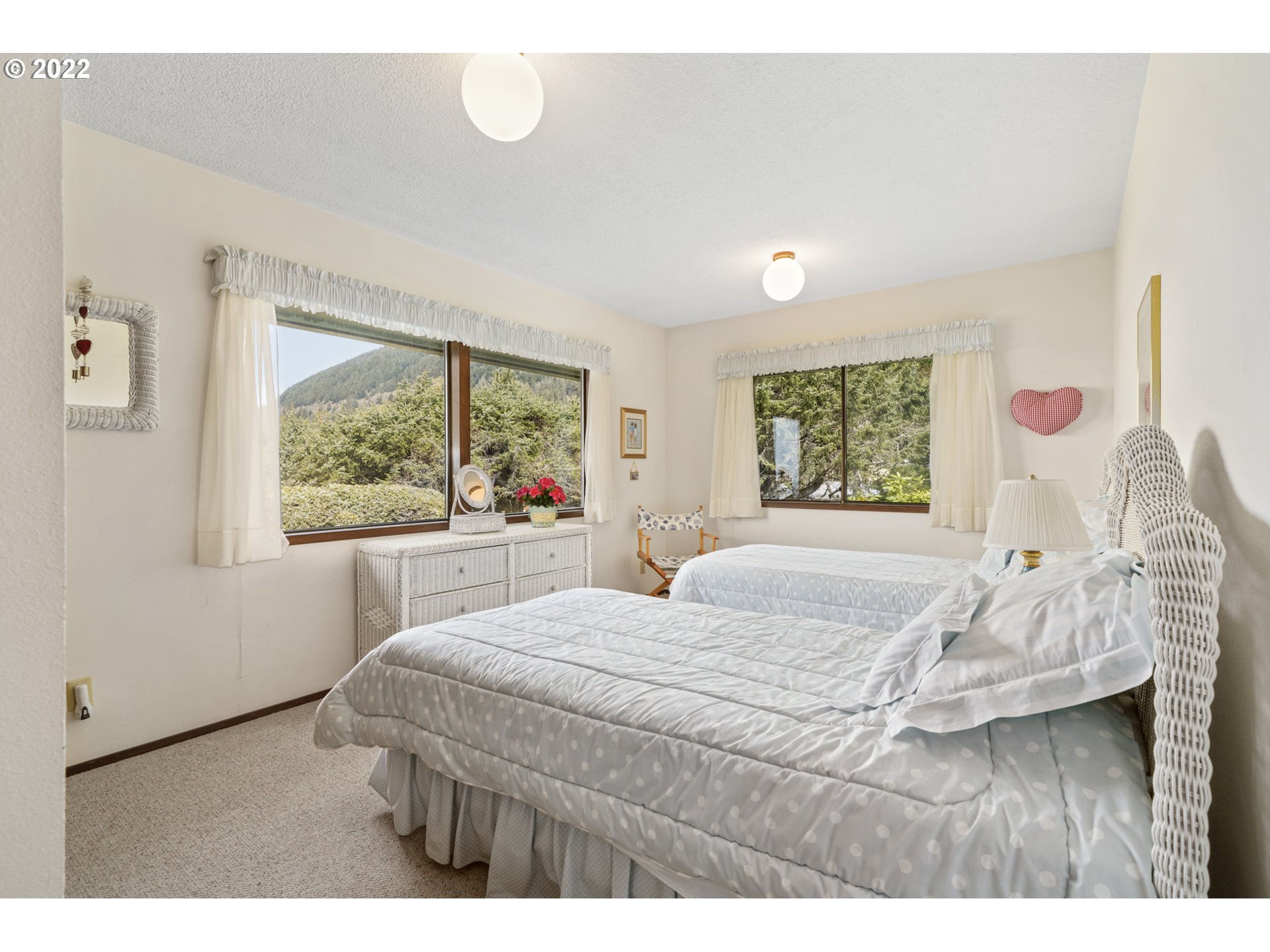 8125 Neahkahnie Road Nehalem, OR 97131 - Photo 21 of 32 a bedroom with a large bed and a large window