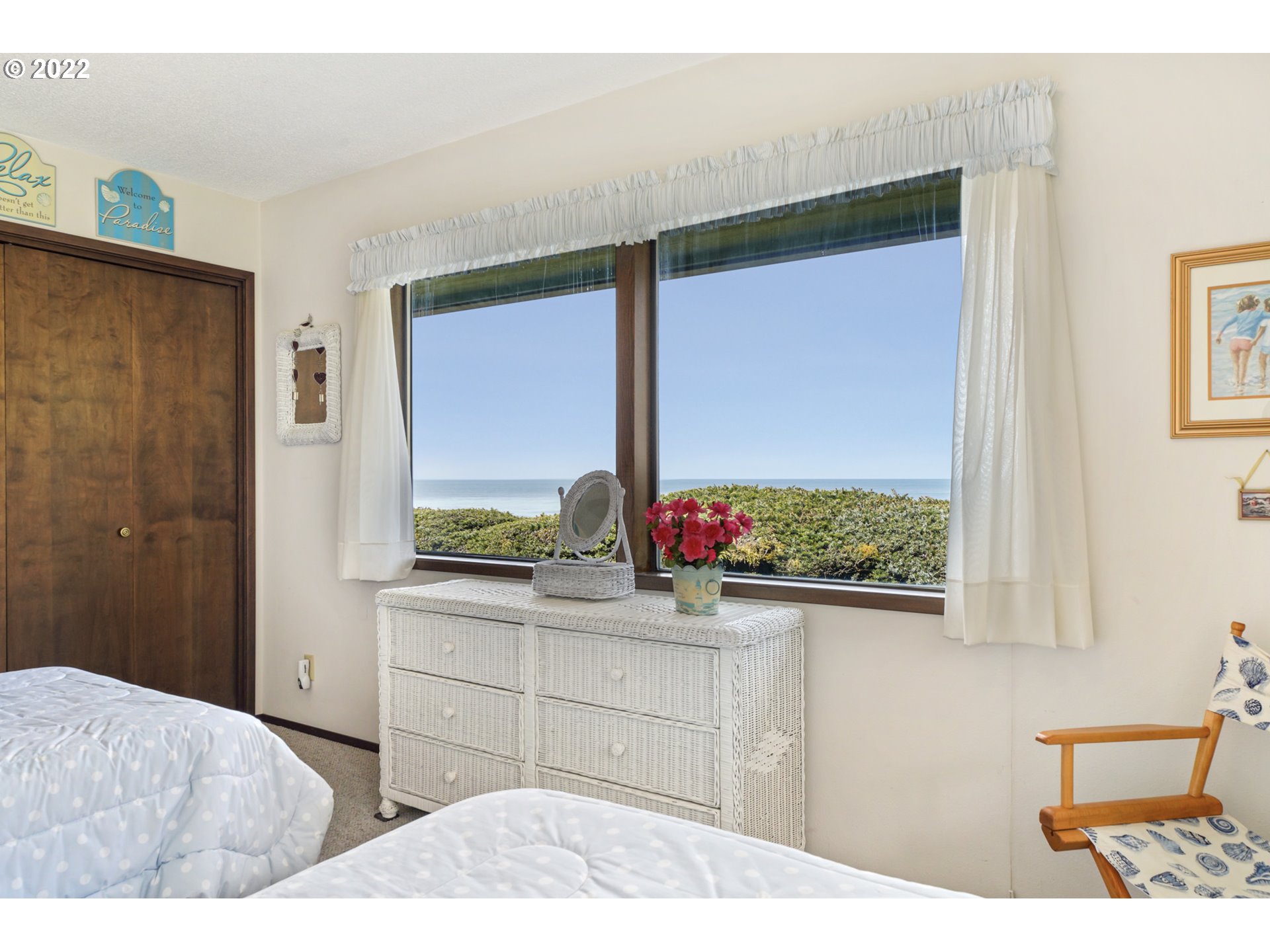 8125 Neahkahnie Road Nehalem, OR 97131 - Photo 22 of 32 a bedroom with a bed and large window