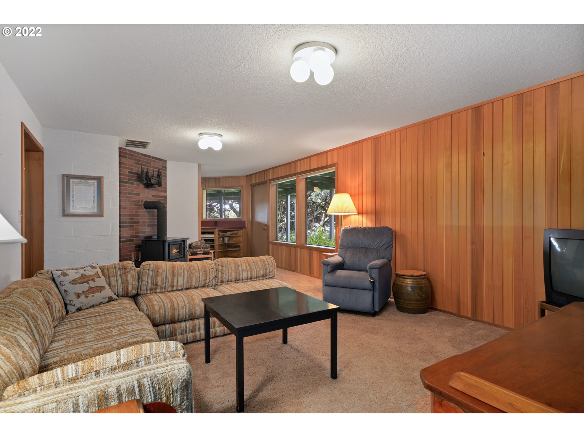 8125 Neahkahnie Road Nehalem, OR 97131 - Photo 26 of 32 a living room with furniture and a flat screen tv