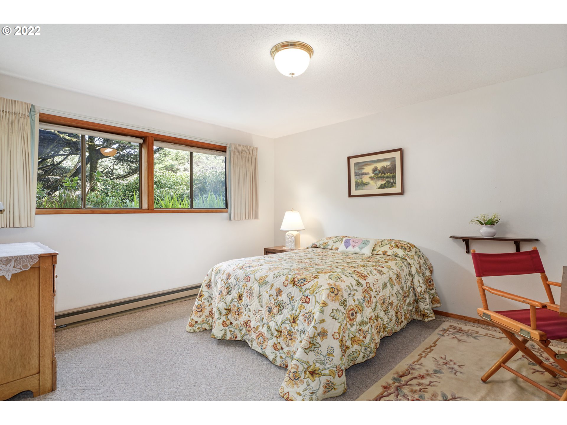8125 Neahkahnie Road Nehalem, OR 97131 - Photo 27 of 32 a bedroom with a bed and a painting on the wall