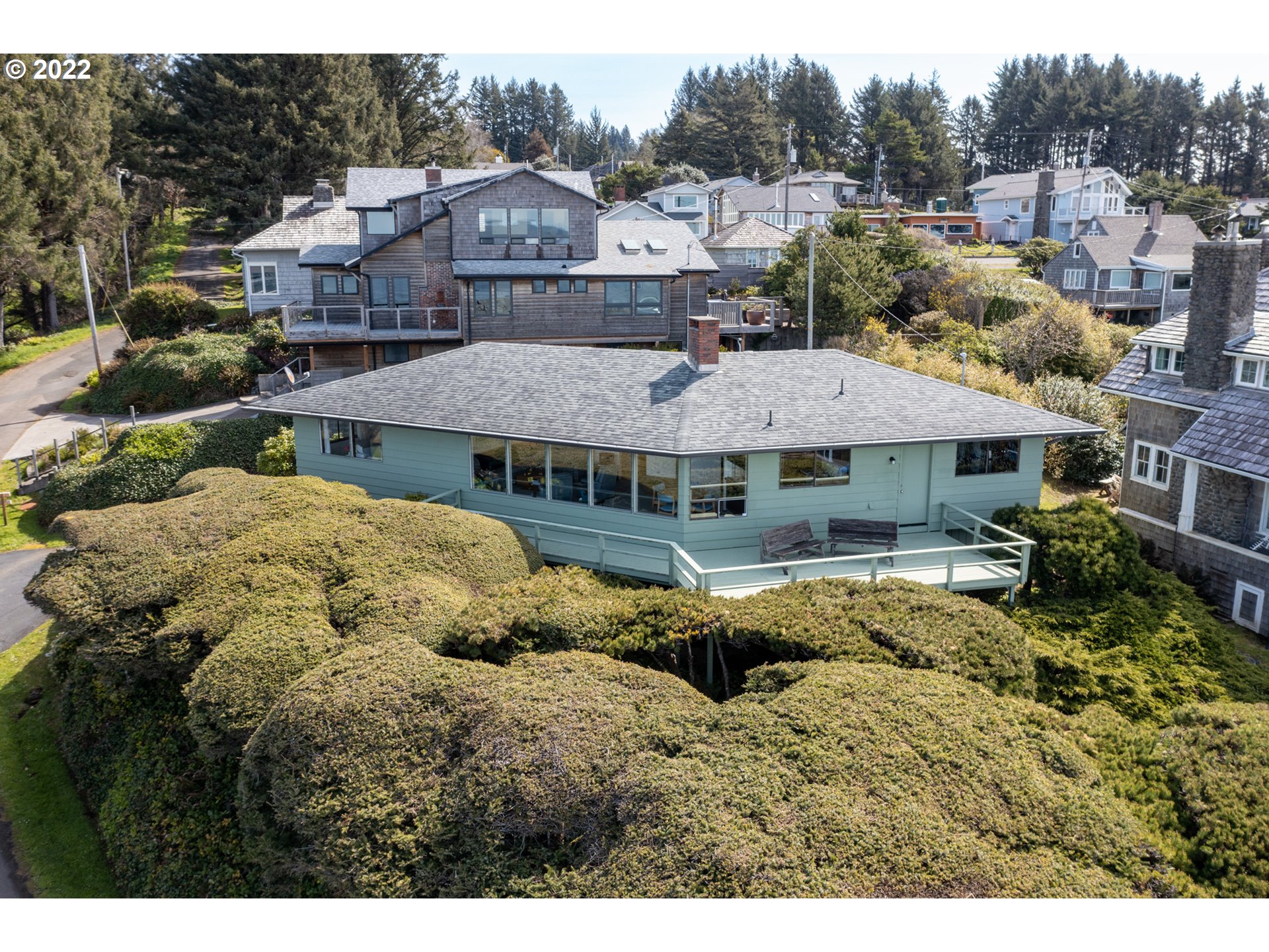 8125 Neahkahnie Road Nehalem, OR 97131 - Photo 30 of 32 a view of a big house with a big yard plants and large tree