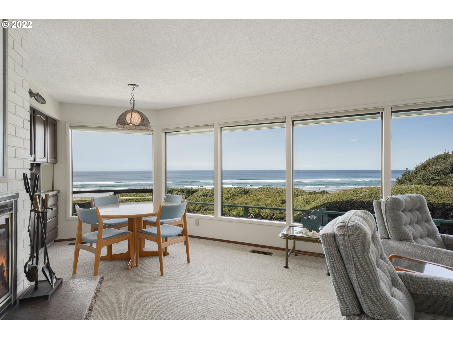 8125 Neahkahnie Road Nehalem, OR 97131 - Photo 3 of 32 a living room with furniture and floor to ceiling window