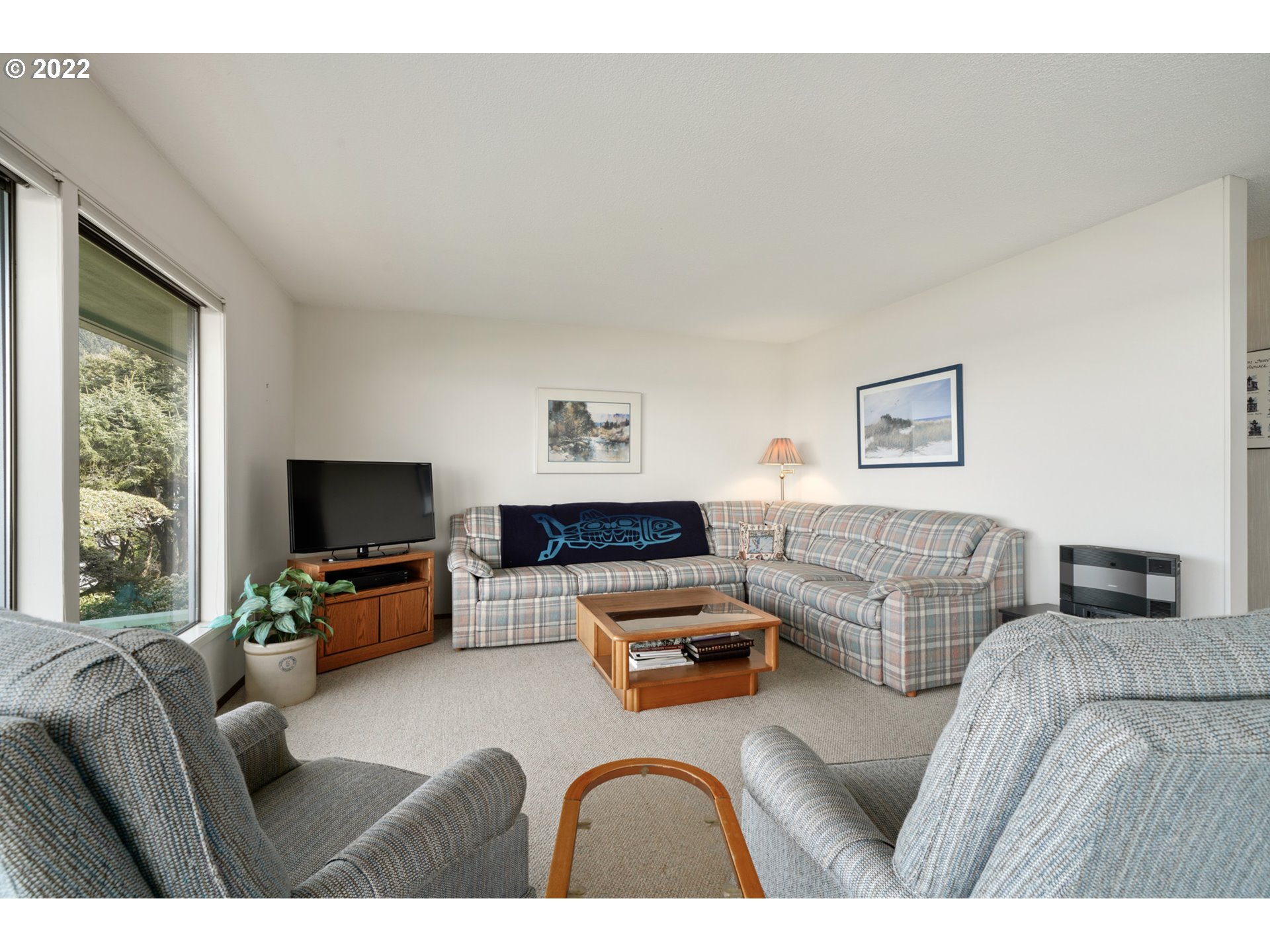 8125 Neahkahnie Road Nehalem, OR 97131 - Photo 9 of 32 a living room with furniture and a flat screen tv