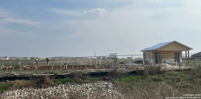 a view of a house with a yard and a pond