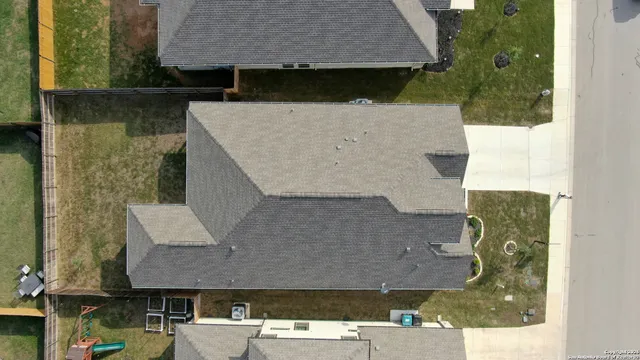 aerial view of a house with a yard
