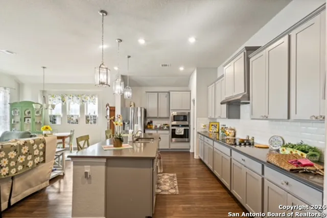 a kitchen with counter top space and living room
