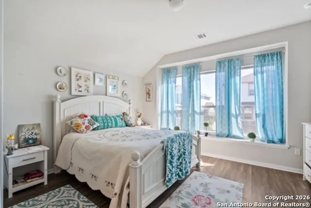 a bedroom with a bed and a large window