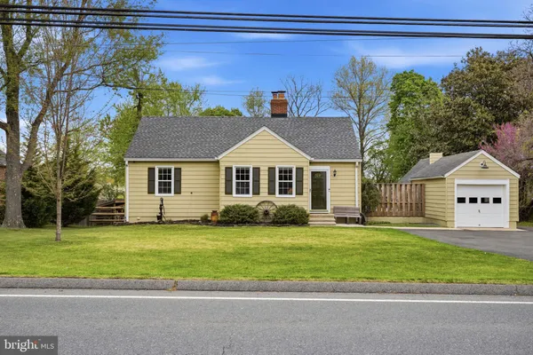 a front view of a house with a garden and yard
