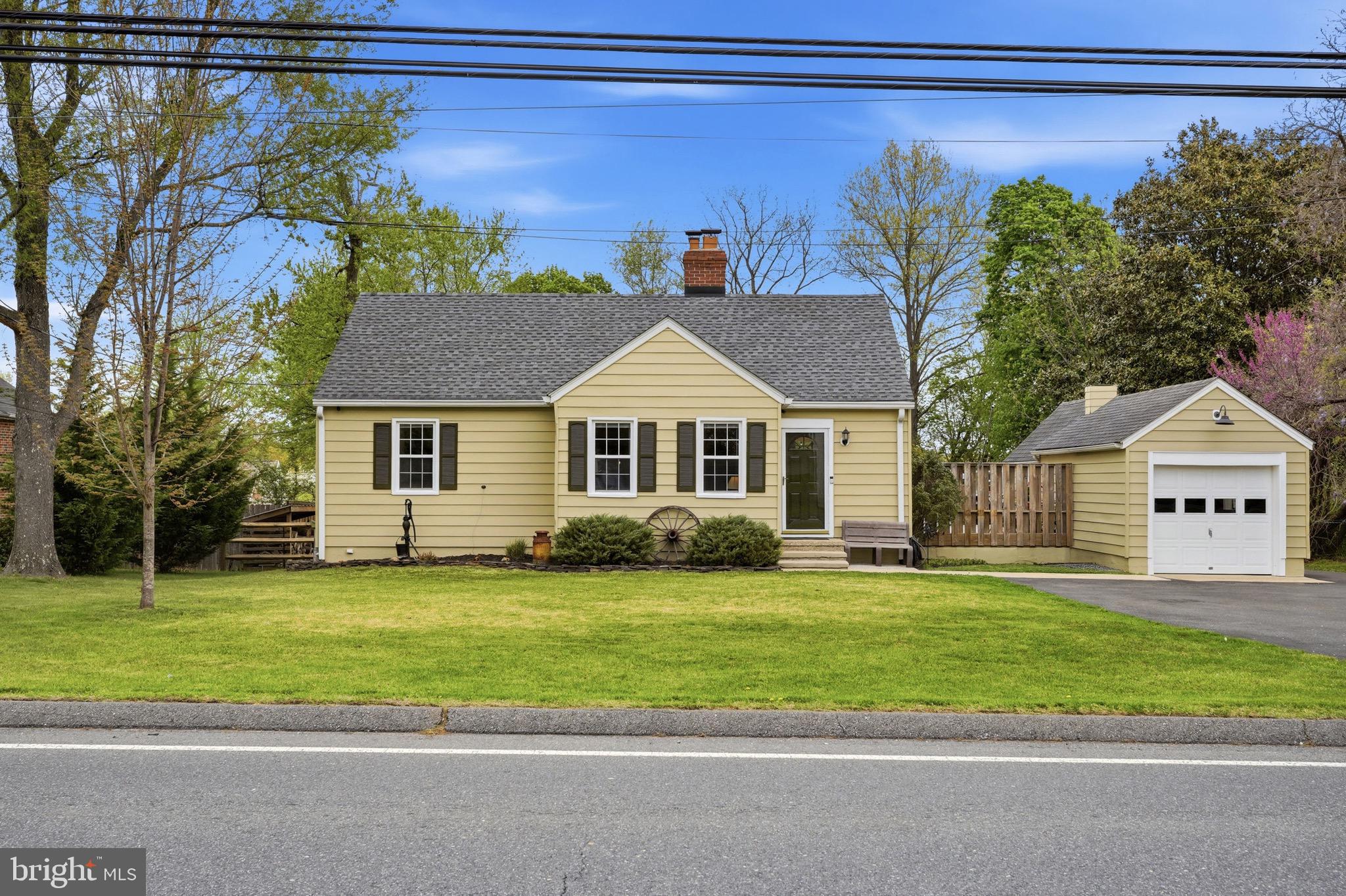 a front view of a house with a garden and yard