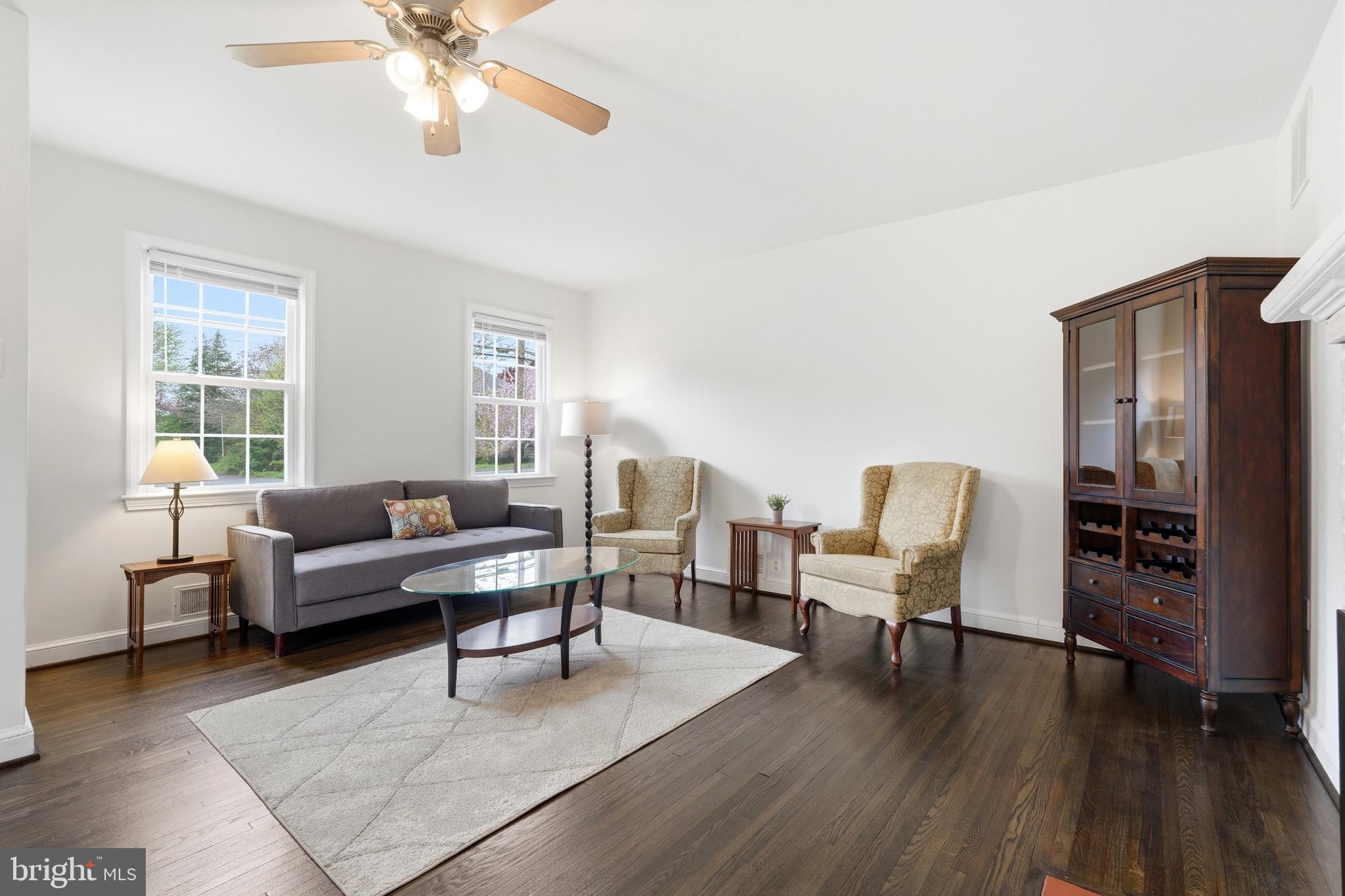 23725 Woodfield Road Gaithersburg, MD 20882 - Photo 11 of 61 a living room with furniture and wooden floor
