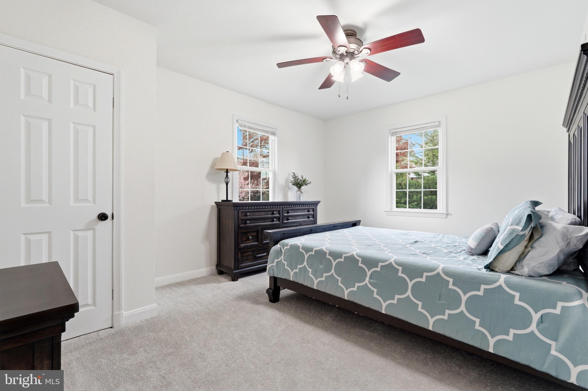 23725 Woodfield Road Gaithersburg, MD 20882 - Photo 17 of 61 a bedroom with a bed and a ceiling fan