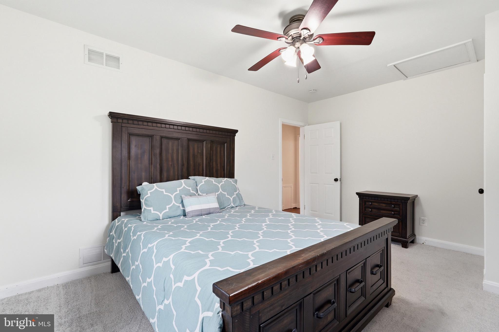 23725 Woodfield Road Gaithersburg, MD 20882 - Photo 18 of 61 a bedroom with a bed and a fireplace