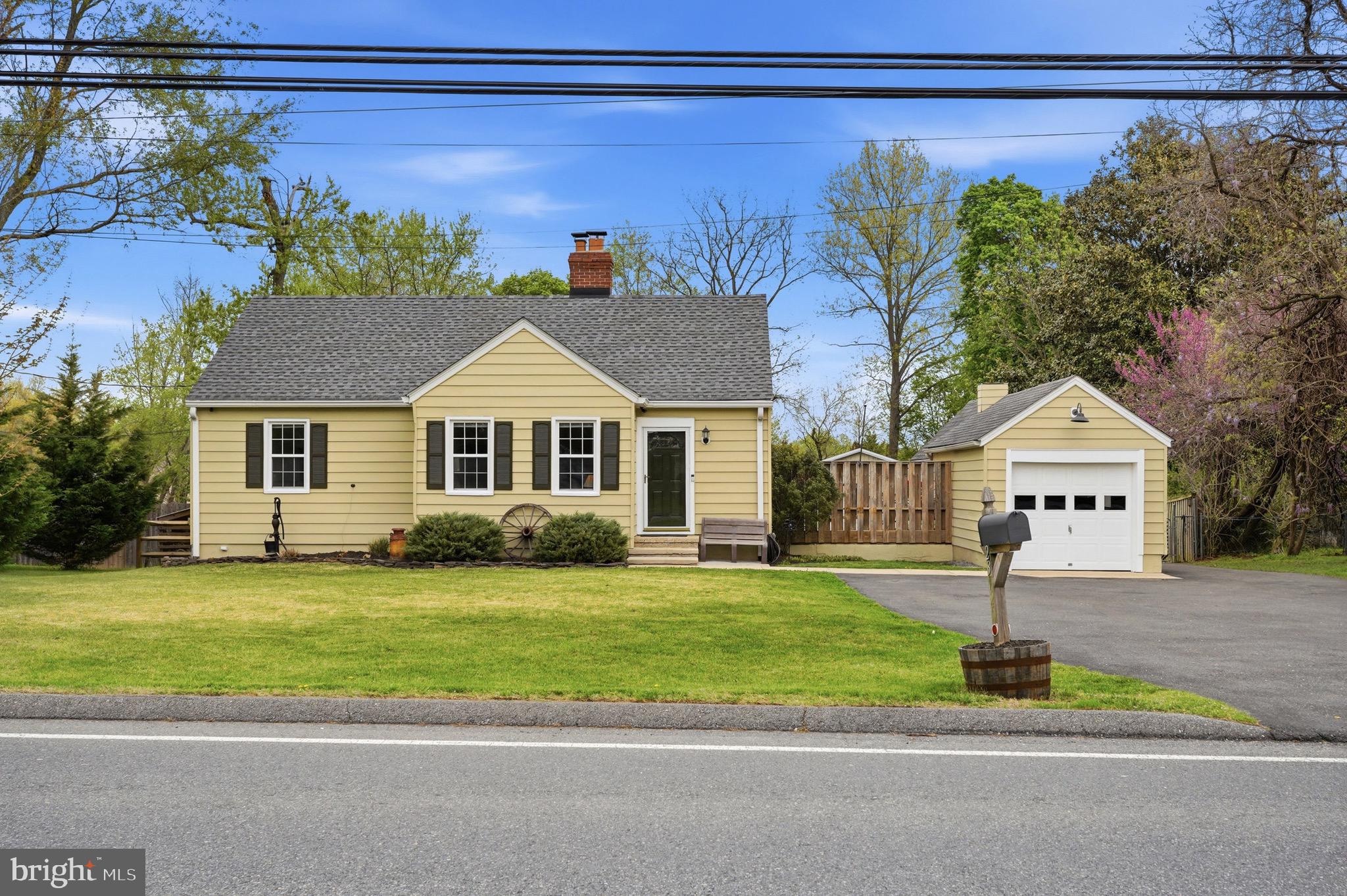 23725 Woodfield Road Gaithersburg, MD 20882 - Photo 2 of 61 a front view of a house with a garden and yard