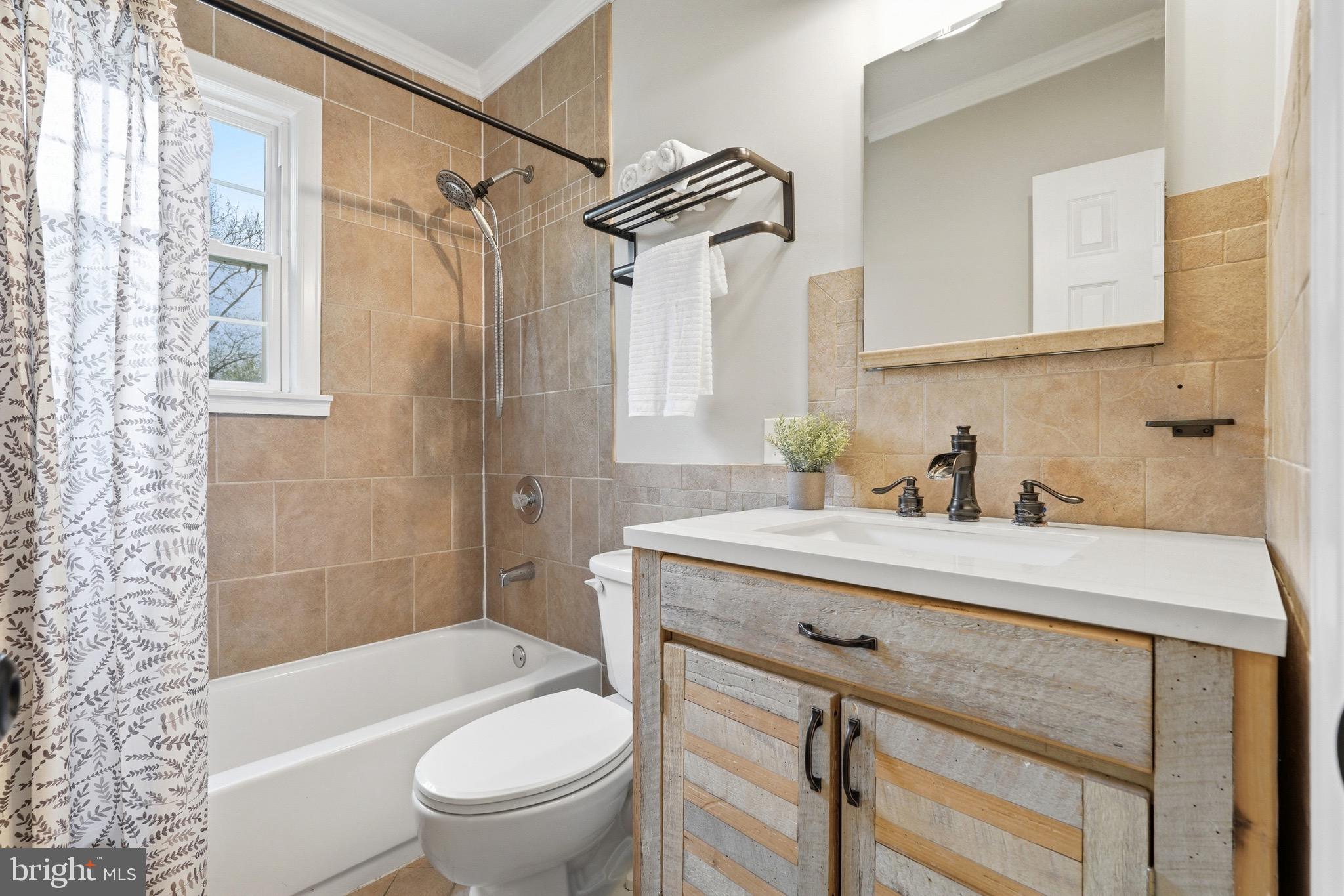23725 Woodfield Road Gaithersburg, MD 20882 - Photo 21 of 61 a bathroom with a sink a toilet and a bathtub