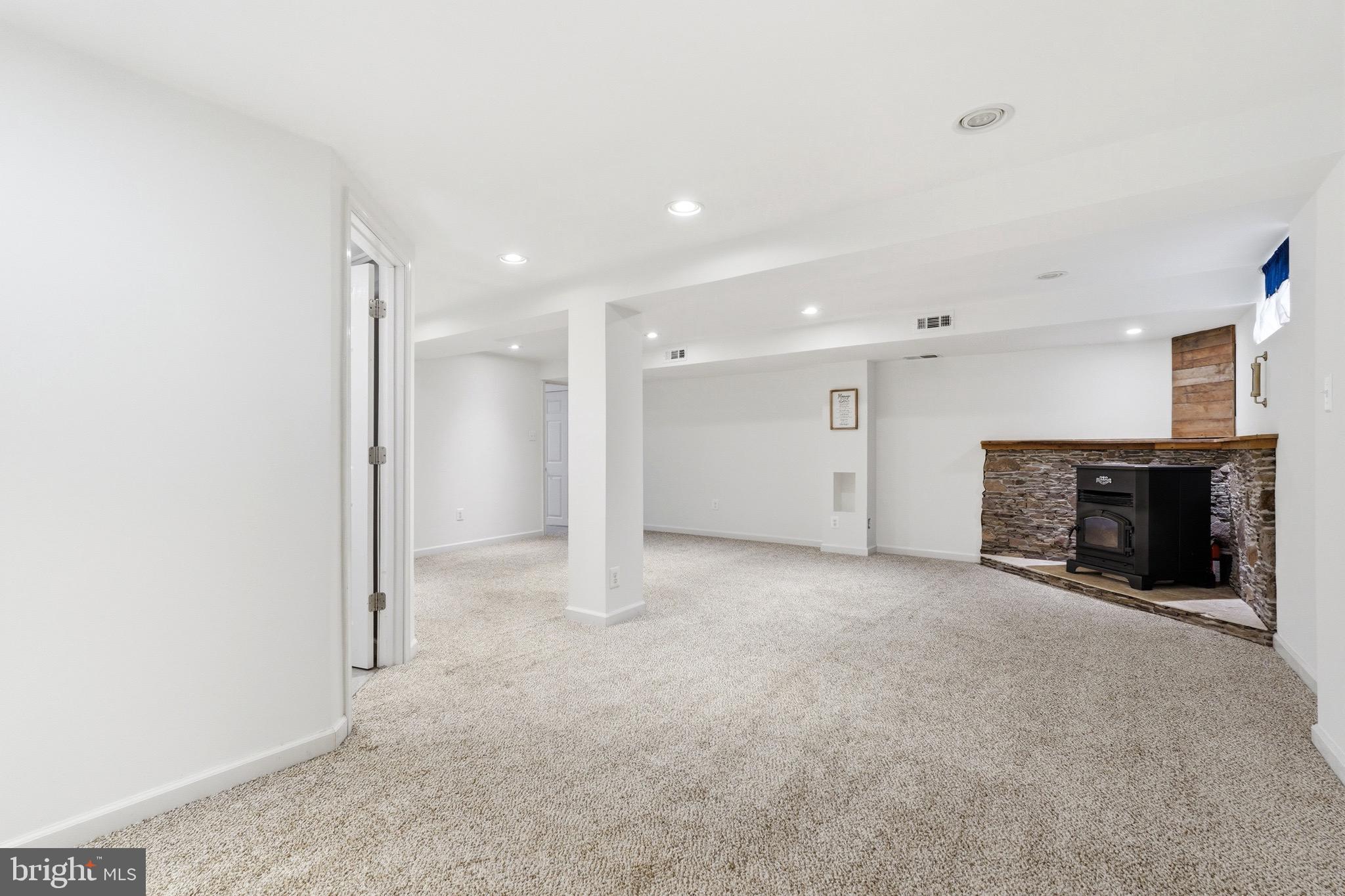 23725 Woodfield Road Gaithersburg, MD 20882 - Photo 28 of 61 a view of an empty room with fireplace and a refrigerator