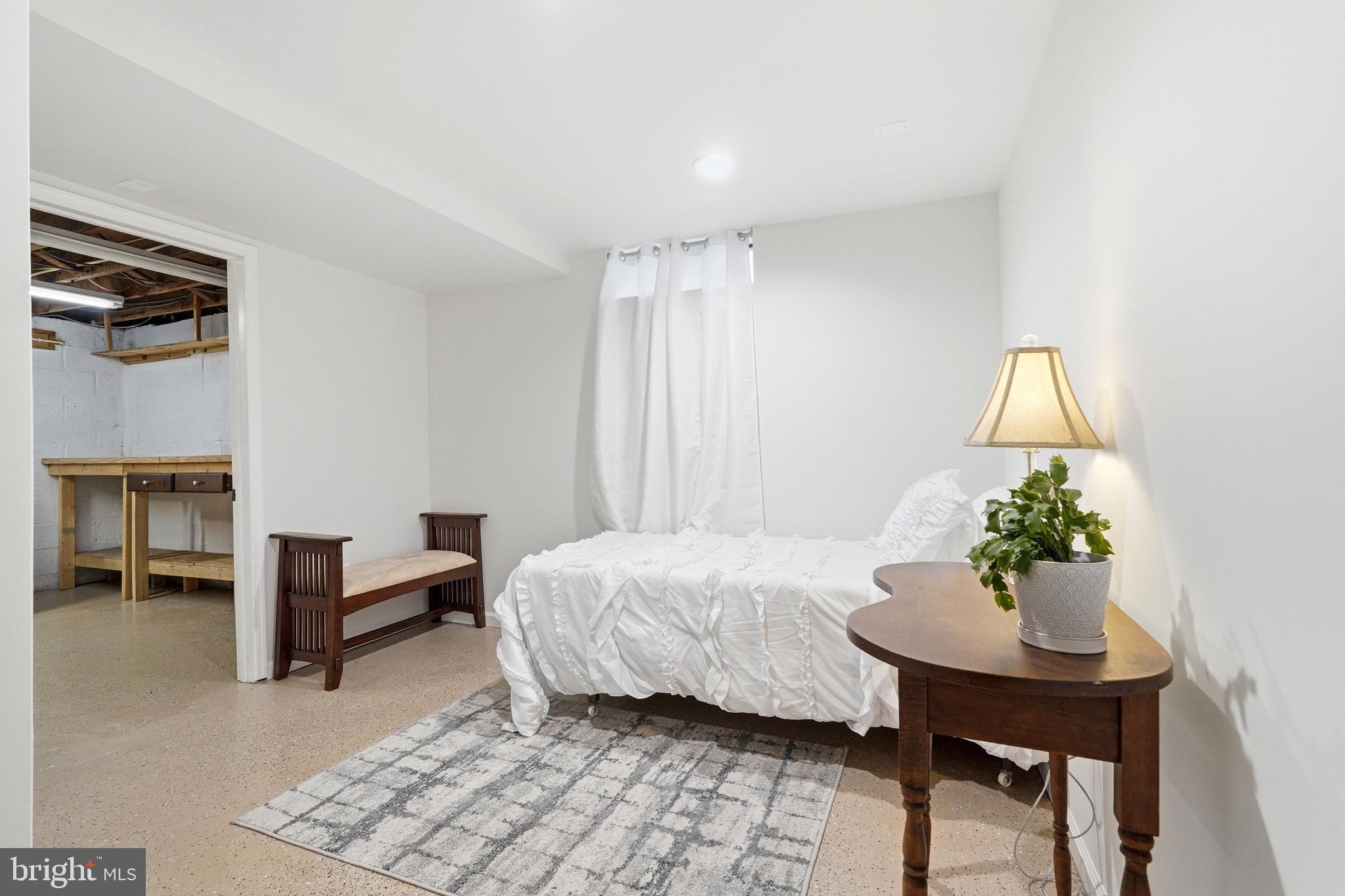 23725 Woodfield Road Gaithersburg, MD 20882 - Photo 29 of 61 a bedroom with a bed and a table chair