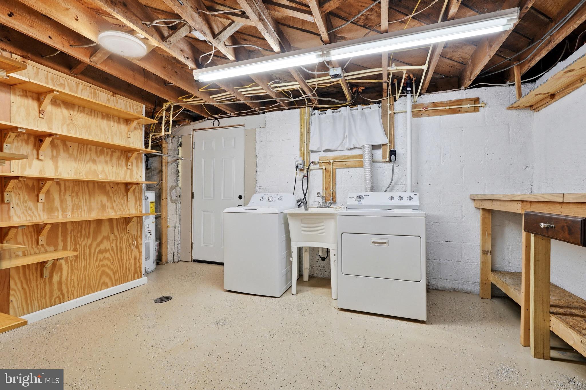 23725 Woodfield Road Gaithersburg, MD 20882 - Photo 32 of 61 a utility room with cabinets dryer and washer