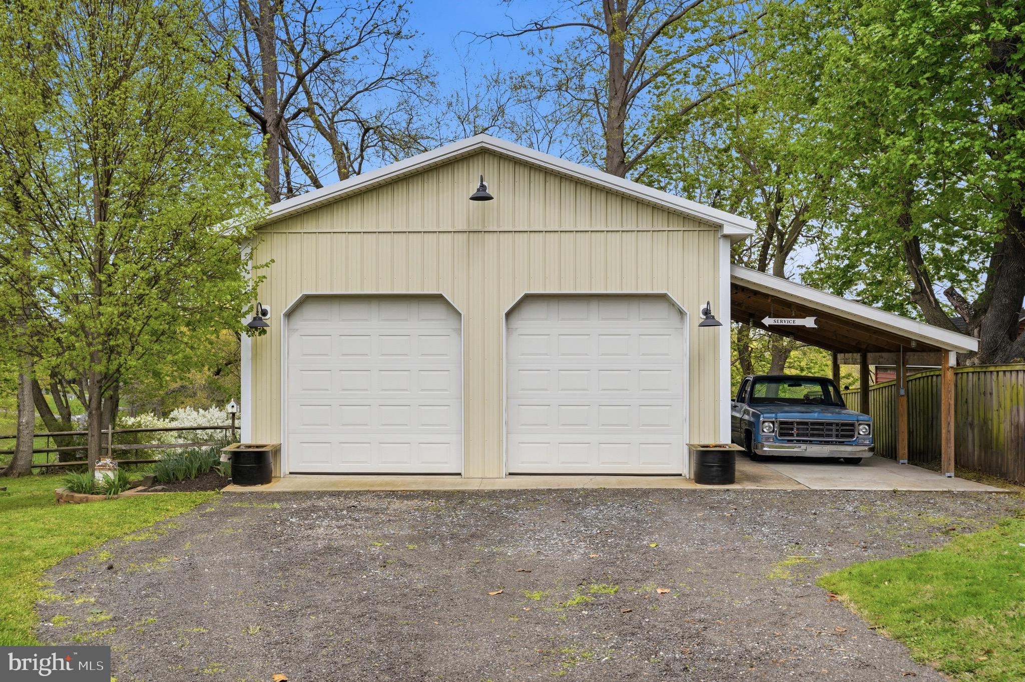 23725 Woodfield Road Gaithersburg, MD 20882 - Photo 43 of 61 a view of garage yard and front view of a house