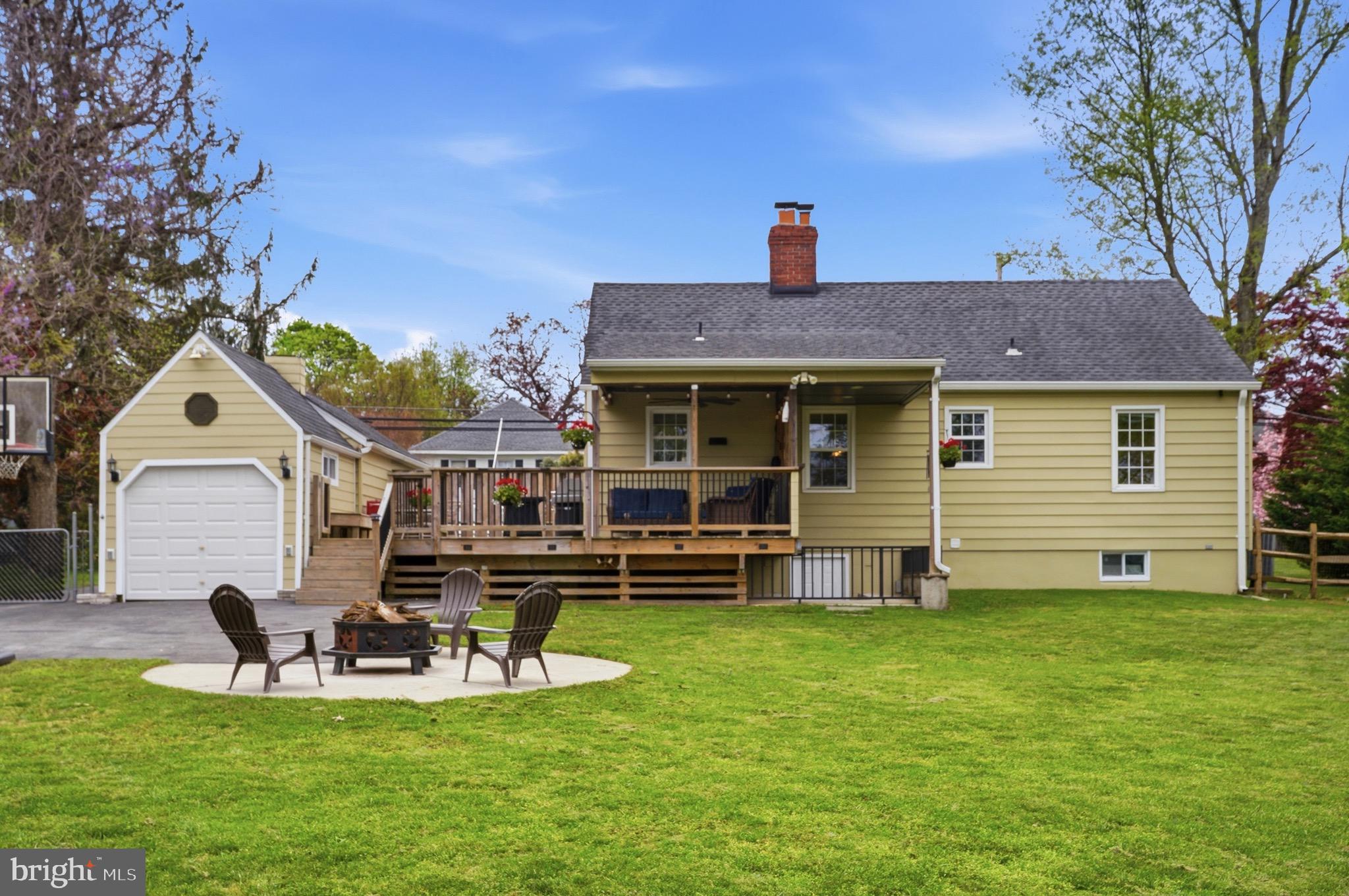 23725 Woodfield Road Gaithersburg, MD 20882 - Photo 47 of 61 a front view of a house with a garden and deck