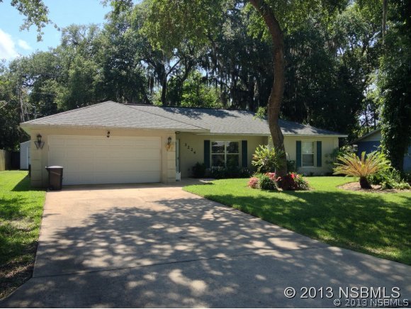 3224 Mango Tree Drive Edgewater, FL 32141 - Photo 1 of 17 a front view of a house with a yard and garage