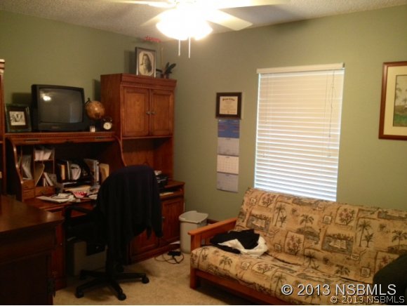 3224 Mango Tree Drive Edgewater, FL 32141 - Photo 12 of 17 a bedroom with a bed and window