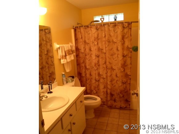 3224 Mango Tree Drive Edgewater, FL 32141 - Photo 14 of 17 a bathroom with a sink a toilet and shower