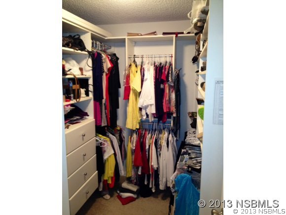 3224 Mango Tree Drive Edgewater, FL 32141 - Photo 16 of 17 a view of walk in closet with clothes