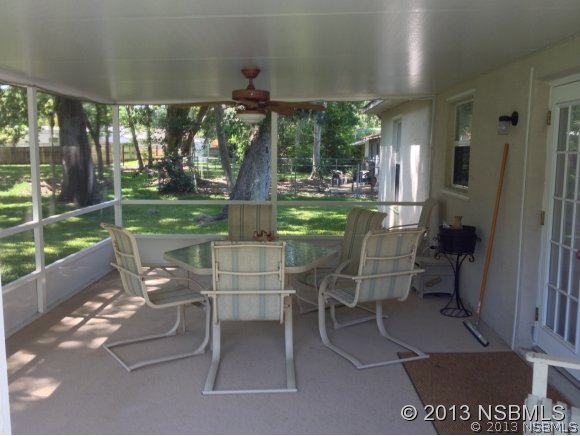3224 Mango Tree Drive Edgewater, FL 32141 - Photo 4 of 17 a patio with yard glass top table and chairs