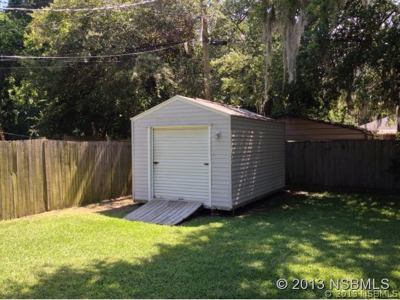 3224 Mango Tree Drive Edgewater, FL 32141 - Photo 5 of 17 a view of a backyard with a small cabin