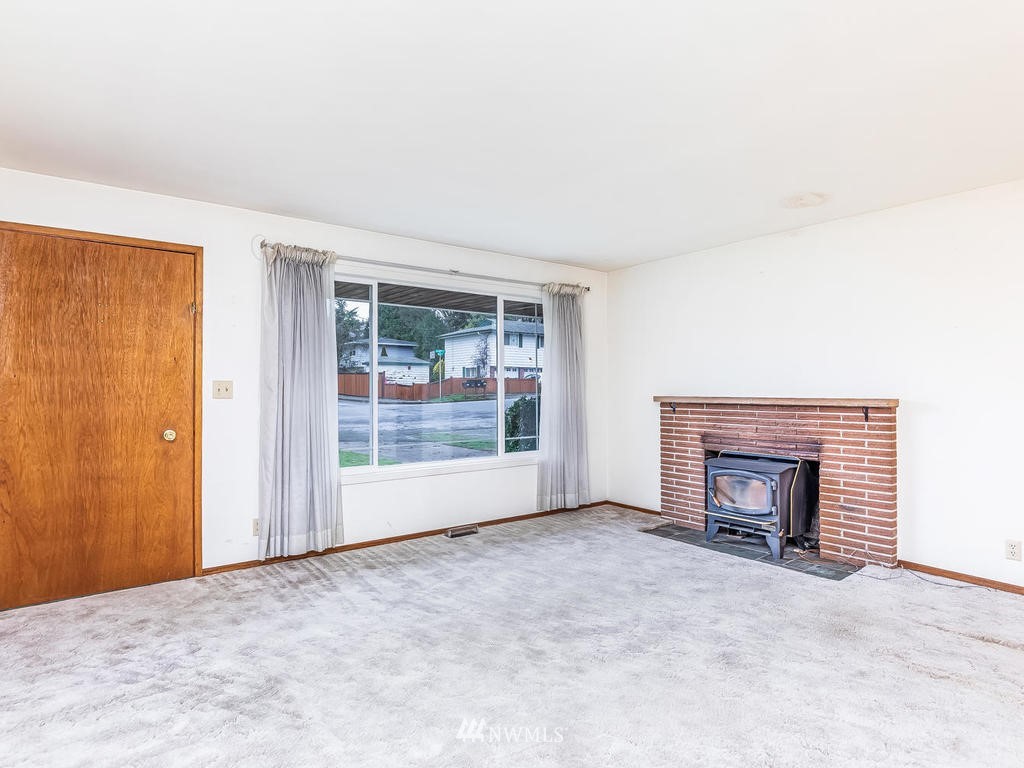 2331 Northeast 12th Street Renton, WA 98056 - Photo 8 of 21 an empty room with fireplace and window