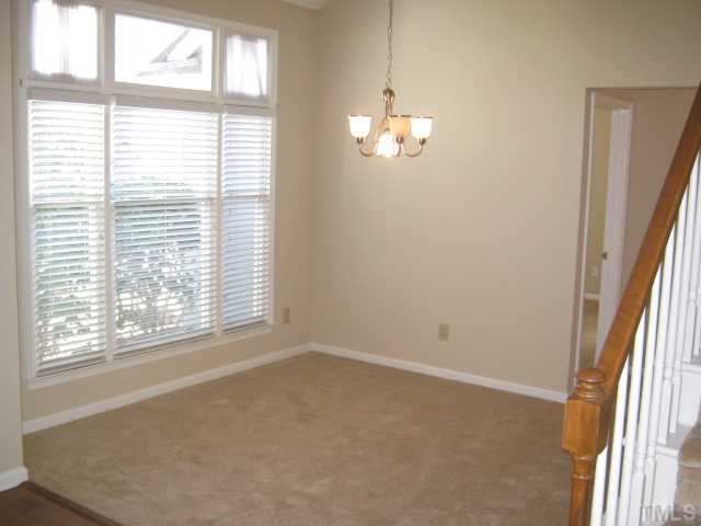 5816 Edgebury Road Raleigh, NC 27613 - Photo 2 of 12 Bright and open dining room features lots of natural light, new carpet 2010, vaulted ceiling and palladium window, new light fixture, and is close to kitchen for ease in serving your guests at dinner parties & family gatherings.